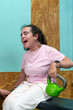 © Javier - Young woman with cerebral palsy is active in a gym, holding a kettlebell, showing determination and strength