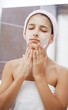 © volff - Teenage girl is cleaning up face with cleansing foam in front of the bathroom mirror. Every day is a ritual procedure for maintaining  a healthy and glowing.