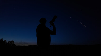 Wall Mural - Amateur astronomer and astrophotographer photographing the evening skies, observing planets, stars, Moon and other celestial objects with a camera.