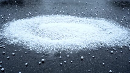Wall Mural - ﻿Timelapse of hail accumulating and melting on a dark pavement motion, minimalist, no text