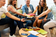 © Alfonso Soler - Friends sharing books during book club meeting
