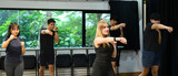 Group fitness class practicing boxing moves with focus and energy indoors