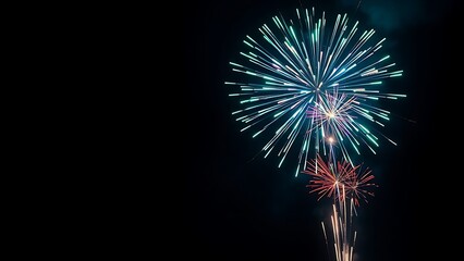 Vibrant fireworks exploding in a night sky, creating colorful sparks and dramatic light trails.