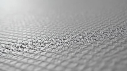 Abstract grey hexagonal mesh texture with shallow depth of field. Modern geometric pattern background.