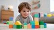 © JAYDA RIN - Happy toddler playing with colorful wooden blocks on carpet in bright cozy room, showing curiosity and joy