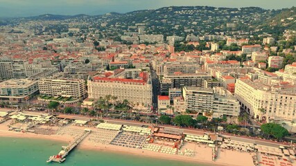 Wall Mural - Drone footage of scenic cityscape with Carlton Cannes hotel in front during daytime.