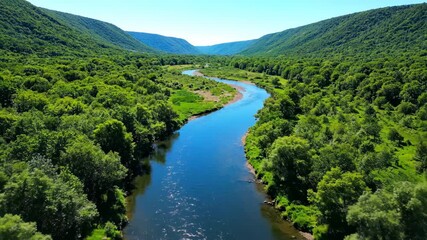 Wall Mural - Gentle aerial glide above a serene river winding through a lush green valley during daylight stream, natural, outdoor