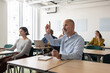 © ReeldealHD images - Man raising his hand to ask a question in class