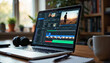 © Angavlan - Laptop showing video editing software with timeline, effects, and controls on screen on desk near coffee cup and headphones. Video editing includes color correction, keyframing.