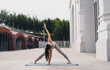 © BullRun - Focused woman holding extended side triangle yoga posture on mat, gaze upward. Conceptual image symbolizing strength, mindfulness, empowerment, balance, resilience, and digital wellness culture.