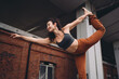 © BullRun - Smiling woman in dancer yoga pose with confident posture, extending one arm forward. Conceptual fitness stock image symbolizing empowerment, wellness, mindfulness, and positive energy.