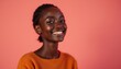© Vancouver - Smiling Black Woman Posing Against a Coral Background