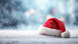 © StokHunt - Santa's hat covered in fresh snow with gently falling snowflakes, representing winter, christmas, and festive holidays