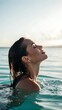 © Tanveer Baloch - Serene Portrait of a Woman with Wet Hair Emerging from Turquoise Water at Sunset