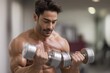 © Виктория Марьенко - Fit man exercises biceps, lifts heavy dumbbells, building strength, sweating during intense gym workout.