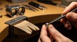 © Khaisan - Detail oriented jeweler setting diamond on engagement ring in workshop with precision tools