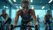 © Raisa - Fit women in gym participate in intense indoor cycling class. Focused athletes pedal vigorously, pushing limits in modern studio. High intensity workout builds strength, endurance, promoting