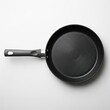 © Durre - Top view of a black non-stick frying pan with a sturdy handle on a light surface