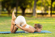 © JackF - Athletic young girl enjoying outdoor yoga practice on glade in green city park on serene summer day, engaged in graceful challenging asana enhancing physical capabilities and inner balance