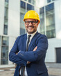 © Miljan Živković - Professional engineer smiling in suit wearing hard hat