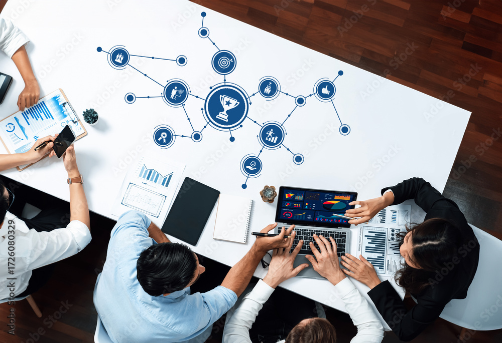 A diverse team collaborates in a modern office environment, engaging in ...