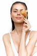 © VICHIZH - Elegant young woman holding a flower near her face, showcasing natural beauty and serene emotions, perfect for spring-themed projects and wellness concepts.