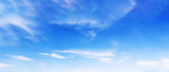 Wall Mural - wispy clouds in blue sky.a serene scene of a bright blue sky with wispy, delicate white clouds, crea