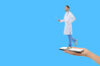 © Atlas - Doctor holds a pointer while standing on a smartphone in hand