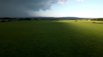 Wall Mural - Timelapse of a hailstorm's shadow quickly sweeping across a vast open field element, motion, precipitation