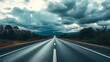 © Lynniee - Panoramic view of an empty road under cloudy skies, capturing a serene and open landscape.