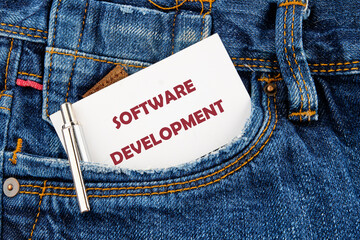 The concept of technology and development. Phrase, words, text SOFTWARE DEVELOPMENT a hint on a piece of paper from your pocket