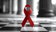 © Unplanned_Pixel - Red ribbon standing tall among black-and-white background, symbol of hope.