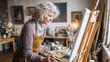 © DaniLana - Older woman painting on canvas in art studio