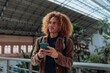 © bernardbodo - Young tourist using smart phone in railway station, madrid