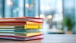 © imagemir - A vibrant stack of colorful folders arranged neatly on a wooden desk, symbolizing organization and productivity.