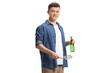 © Ljupco Smokovski - Young man holding a grill turner and a bottle of beer