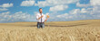 © Ljupco Smokovski - Businessman in a middle of a field holding wheat stalks
