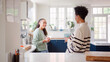 © Monkey Business - Mature Mother Talking With Teenage Daughter At Home In Kitchen Drinking Hot Drinks Together