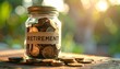 © photostockatinat - Jar full of coins labeled 'Retirement', suggesting savings and financial planning for the future