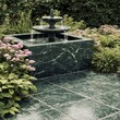 © Waheed - Outdoor garden fountain base designed with green marble tiles surrounded by flowers and lighting creating harmonious natural elegant environment