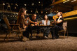 © SOMKID - Happy Friends Celebrating Together at Night, Young Asian Group of Friends Having Fun and Toasting Drinks Outdoors At Night, Enjoying a Celebration Concept.