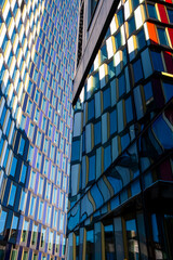 Reflections of colored glass panels on modern office tower façade, Scandinavian corporate design showing clarity, geometry and copy space background for branding, posters and layouts