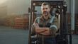 © Bernd Schmidt - Male forklift driver standing in front of his forklift with his arms crossed and wearing work clothes generative AI