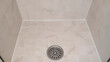 © Frank - Clean tiled shower floor with central drain