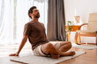 © Maria Vitkovska - Relaxed bearded middle aged man practicing mindfulness and meditation indoors