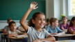 © Liera - A joyful young girl of Middle-Eastern descent raises her hand in a classroom, eager to participate in the lesson.