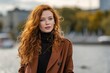 © Iftikhar alam - Young woman showcases chic autumn outfit near waterfront in city while enjoying a crisp fall day filled with vibrant colors and soft sunlight
