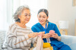 © CandyRetriever  - Female caregiver take care and knitting needles with senior woman in living room. Retirement rehabilitation nursing home. Home medical wellness healthcare services and elderly people mental health.