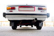 white retro car in a parking lot, rear and bottom view, close-up, retro transport concept