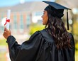 © For - Proud graduate holding diploma outdoors